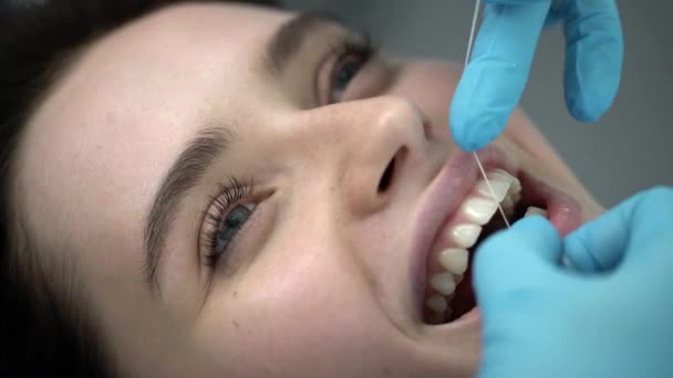 Pretty womans teeth cleaning in dental clinic - Filmagem, Vídeo