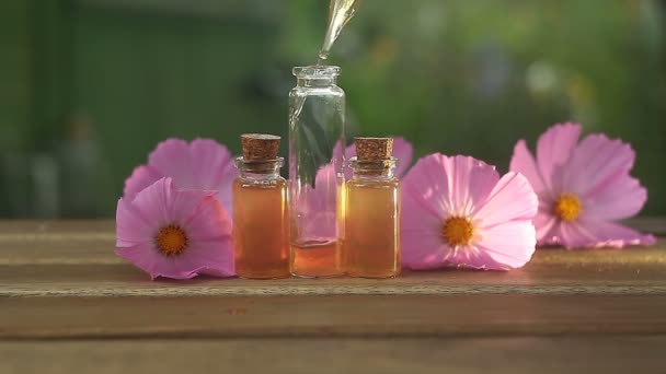 Essence of  flowers on table in beautiful glass Bottle - Footage, Video