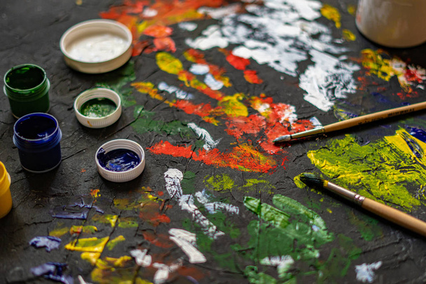 gouache paints with brushes, concrete surface decorations - Fotografie, Obrázek