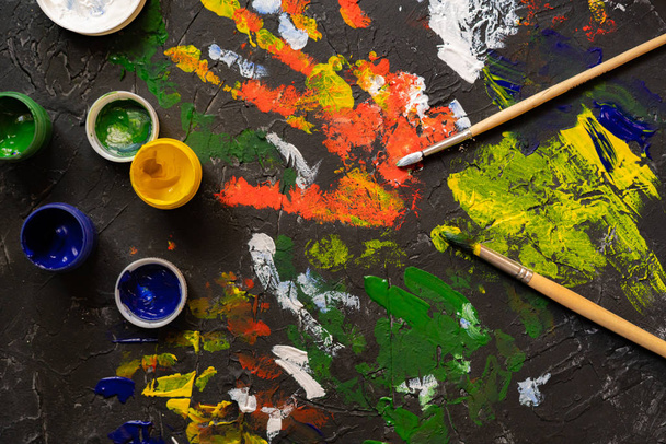 gouache paints with brushes, concrete surface decorations - Φωτογραφία, εικόνα