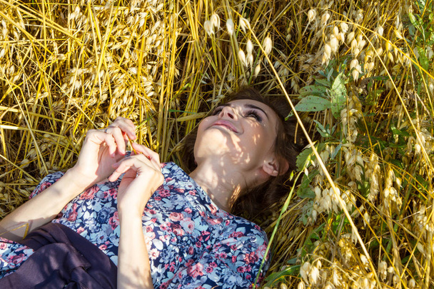 girl lies in the field among ripe ears - Photo, image