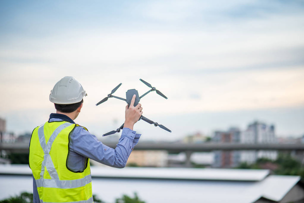 Ingeniero asiático usando dron para estudio de sitio
 - Foto, imagen