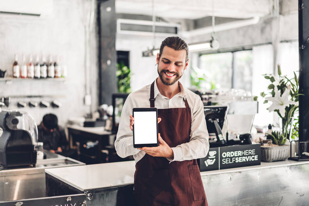 Portrait of barista man small business owner standing with table - Foto, immagini