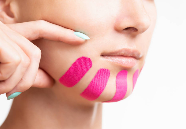 Woman with kinesio tape on chin for facelift. - Zdjęcie, obraz