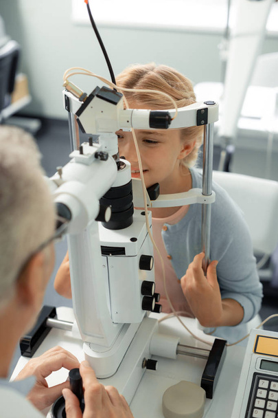 Beautiful girl visiting ophthalmologist at the weekend - Foto, Imagem