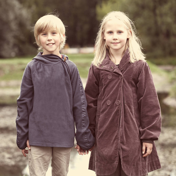 First love, romantic concept, little boy and girl holding hands - Photo, Image
