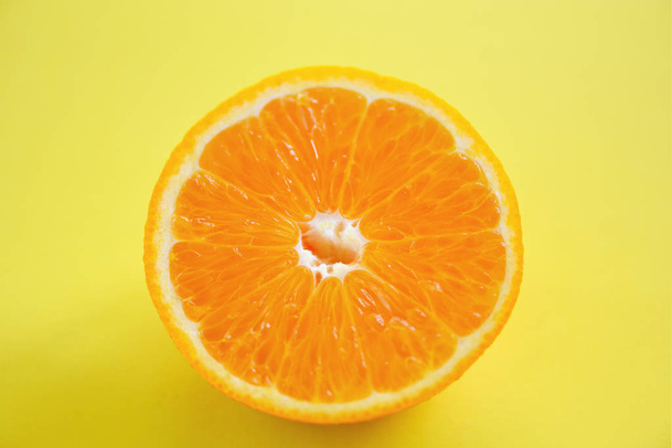 φέτα πορτοκαλί σε κίτρινο φόντο/φράχω φρέσκο πορτοκαλί FRU - Φωτογραφία, εικόνα