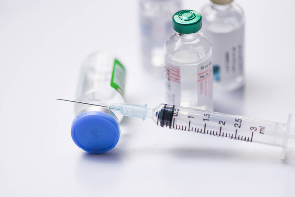 Medicine bottles glass for syringe injection needle on white bac - Photo, Image