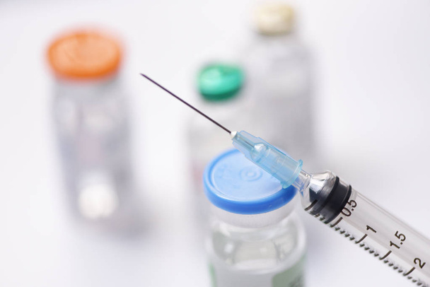 Medicine bottles glass and syringe injection needle on white bac - Photo, Image