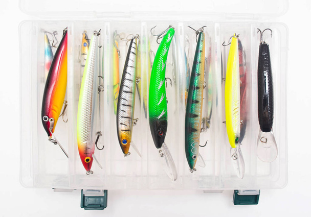 Fishing suitcase with multi-colored bait lure for fishing on a white background, wobbler - Photo, image