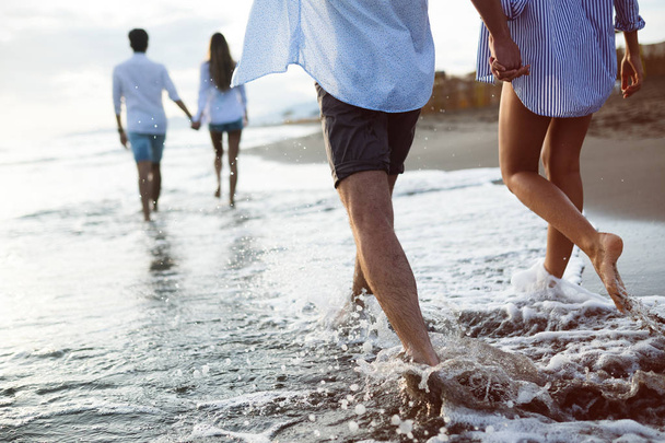 Group of friends running on beach and enjoying summer holiday - Fotoğraf, Görsel