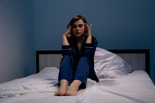 Worried and sleepy woman in the bed. Insomnia concept. - Фото, изображение