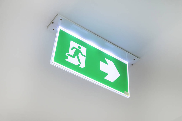 Fire exit sign. Emergency fire exit door exit door on ceiling. G - Photo, Image