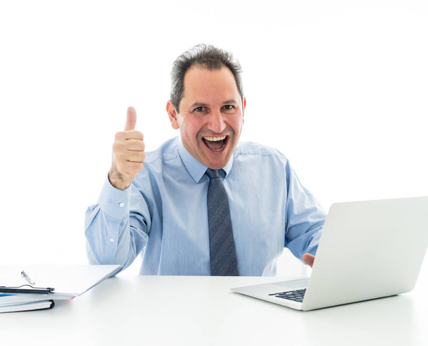 lächelnd selbstbewusster Geschäftsmann mittleren Alters, der am Laptop arbeitet und Daumen nach oben zeigt, um sich bei der Arbeit glücklich zu fühlen. in Wirtschaft, positivem Umfeld und Technologie. isoliert auf weiß. - Foto, Bild