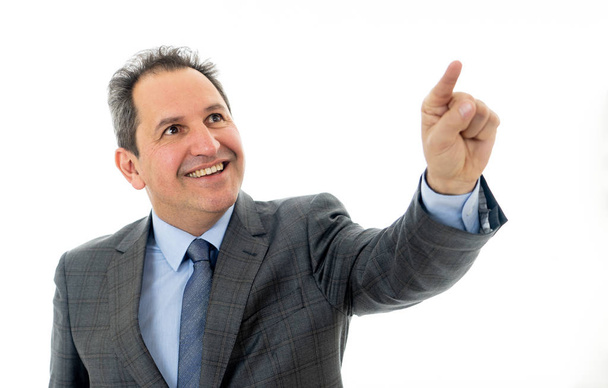 Studio portrait of Mature business man pointing as using a virtual desktop or screen. Smiling feeling confident and successful. People business education, success and new technology at work concept. - Φωτογραφία, εικόνα