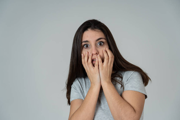 Close up of young woman feeling scared and shocked making fear, anxiety gestures. Looking terrified and covering herself from something. Copy space. People and Human expressions and emotions concept. - Foto, Imagen