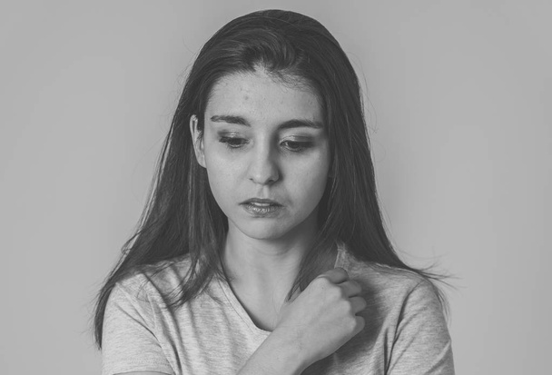 Black and white portrait of a young sad woman, serious and concerned, looking worried and thoughtful. Feeling sorrow and depression. With copy space. In facial expressions and human emotions concept. - Foto, Imagen