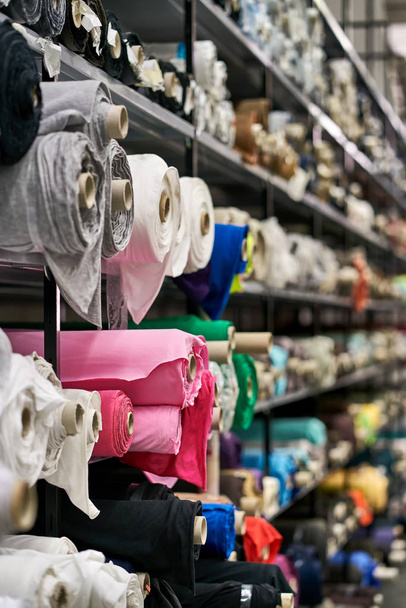 Fabric warehouse with many multicolored textile rolls - Foto, Imagem