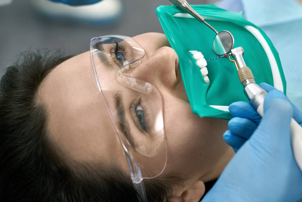 Pretty womans teeth treatment in dental clinic - Fotó, kép