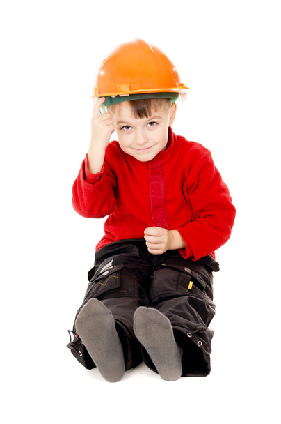 Happy little boy sits with a helmet - Foto, afbeelding