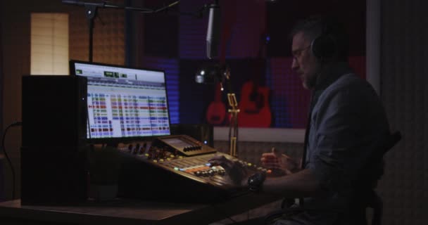 Man recording his own voice part in studio - Footage, Video