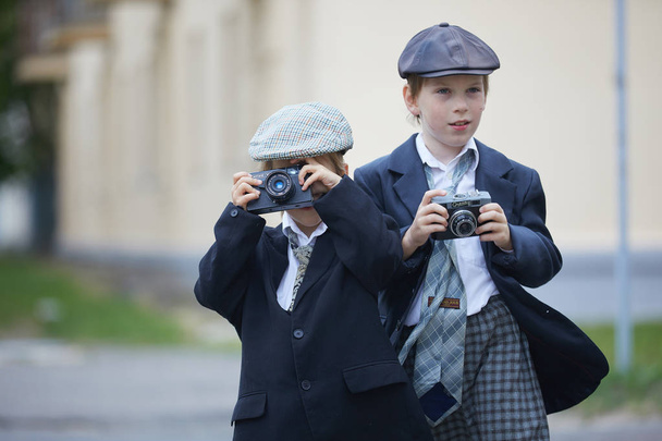 Children having costume party with cameras outdoors - Foto, Bild