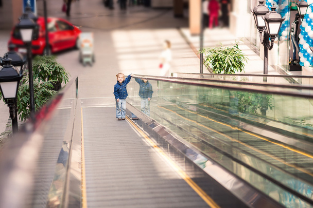 Cute little child in shopping center on escalator - Photo, image