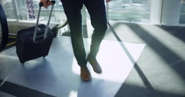 Front view of businessman walking with luggage in lobby at office and adjusting tie.  - Footage, Video