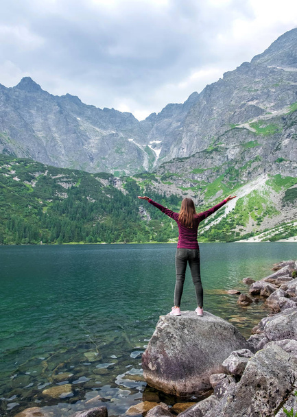 Young tourist girl on Lake Morskie Oko (Sea Eye), Zakopane, Poland, High Tatras - Photo, Image