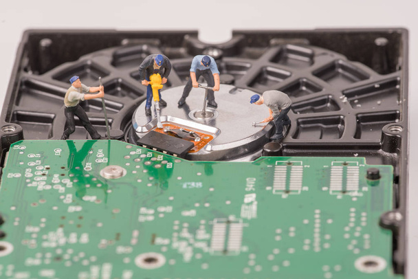 technicial team miniature people repairing  hard drive. Figures  - Photo, Image