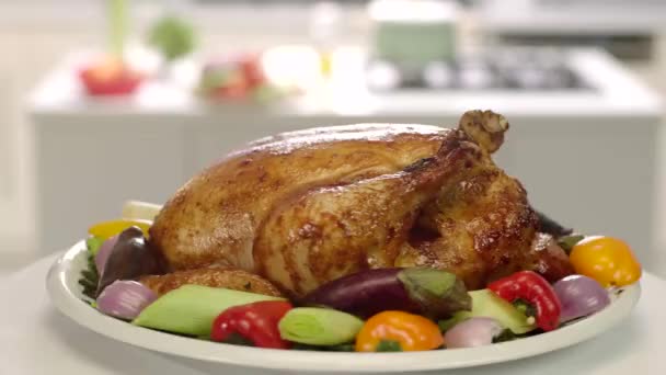 view of roasted chicken with vegetables turning on table - Footage, Video