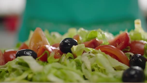 slow motion of black olives falling in salad  - Footage, Video