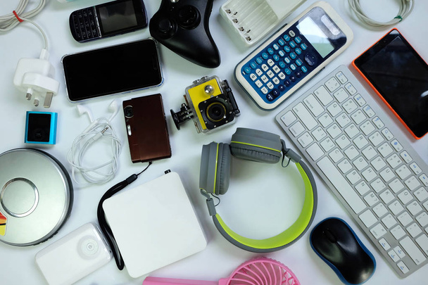 Nombreux gadgets électroniques modernes utilisés pour une utilisation quotidienne sur le sol blanc, concept de réutilisation et de recyclage, vue de dessus
. - Photo, image