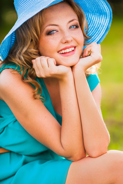 Happy blonde woman wearing hat - Fotó, kép