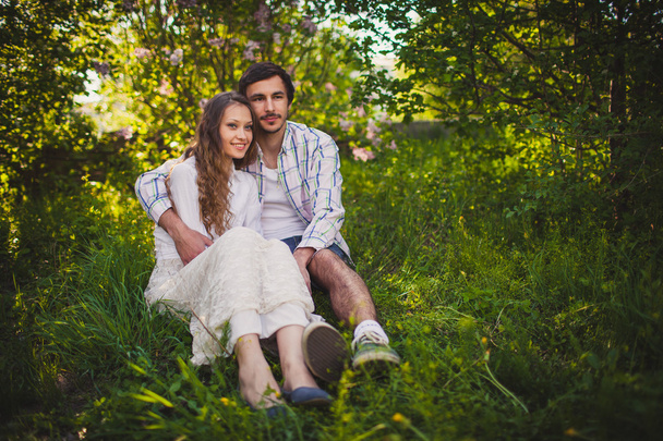 Couple in love sitting at summer park - Фото, изображение