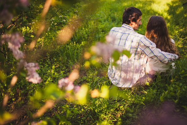 Couple in love sitting at summer park - Fotografie, Obrázek