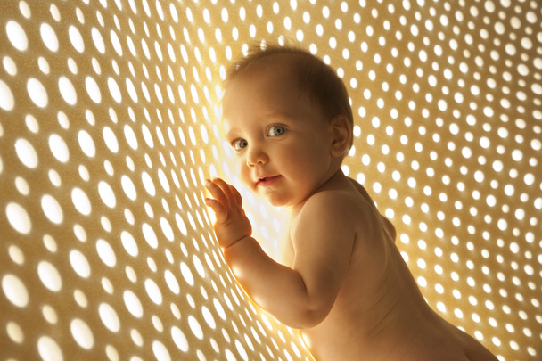 Naked baby with rays of light network - Foto, imagen