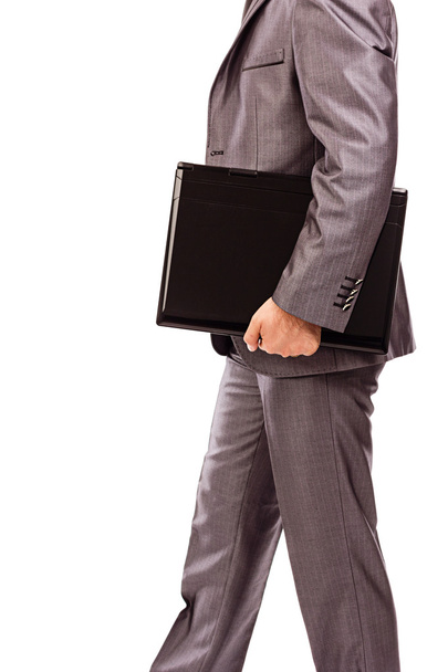 Businessman with laptop under his arm - Foto, imagen
