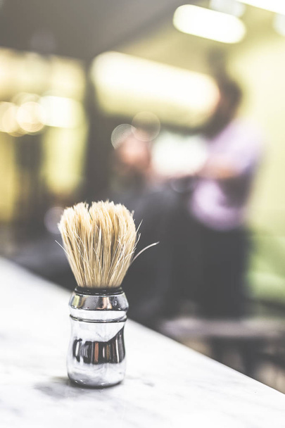 Brush for shaving beard. Blurred background of men hair salon. - Фото, изображение
