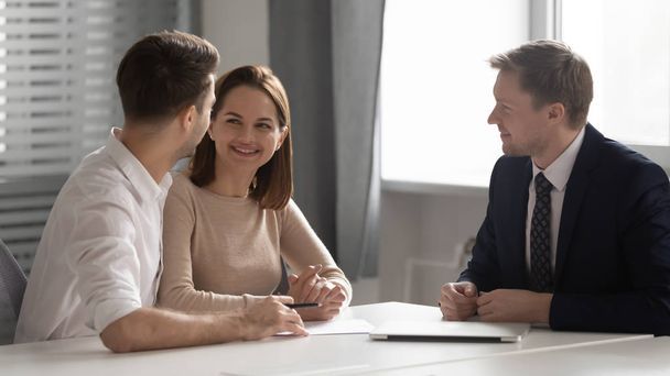 Happy young family couple making decision meeting bank manager insurer - Photo, Image