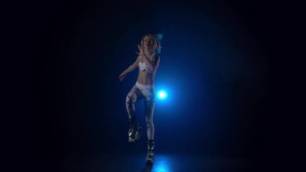 Slow motion of pretty woman performing exercises in kangoo jumps. - Materiał filmowy, wideo