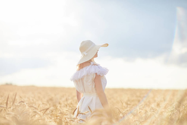 caucasian woman in hat on wheat field during daytime - Zdjęcie, obraz