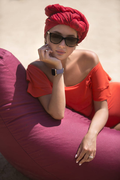 young attractive woman in sunglasses and swimsuit resting on the beach - Zdjęcie, obraz