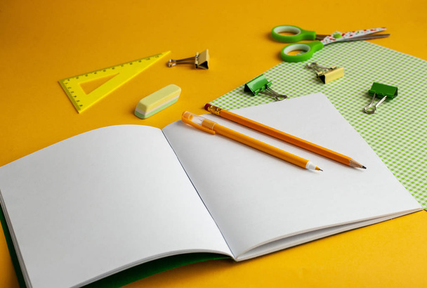 Bright modern minimalistic stationery for schoolwork on a yellow - Фото, изображение
