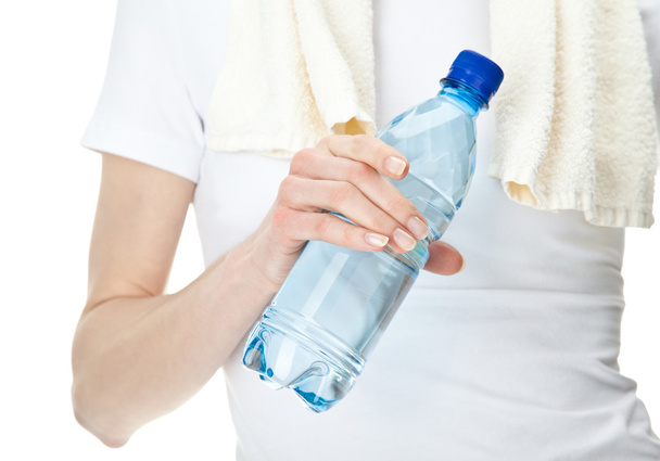 Female hand holding bottle of drinking water - Fotoğraf, Görsel