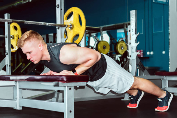 young man does push-up exercise in the gym - Photo, Image