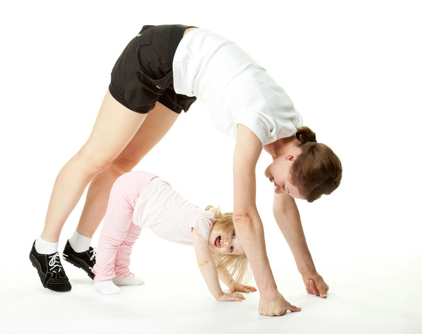 Joyful baby and her mother exercising - Фото, зображення