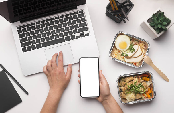 Woman making online order of healthy food by cellphone - Photo, Image