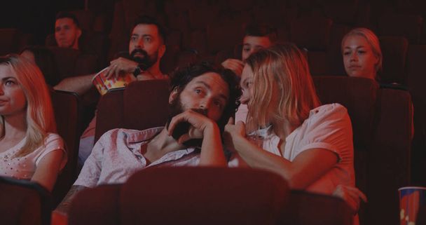 Couple disturbing cinema audience with talking - Photo, Image