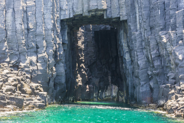 view of stone cave with turquoise water - Foto, Imagem